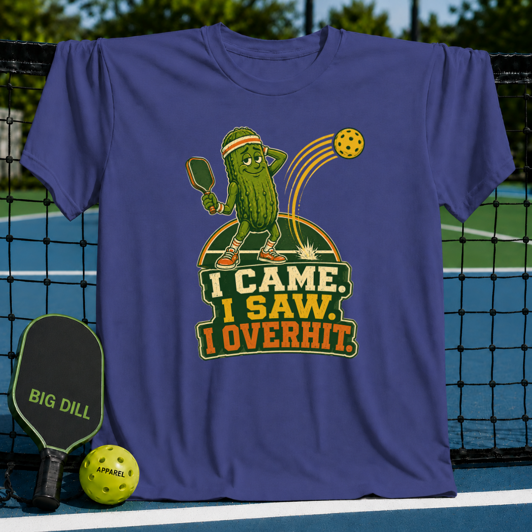 Purple Overhitter pickleball t-shirt featuring a cartoon pickle character hitting a ball with the text I Came, I Saw, I Overhit.