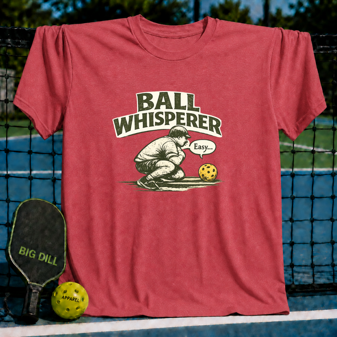 Red unisex t-shirt featuring a vintage Ball Whisperer graphic of a player crouching and talking to a pickleball.