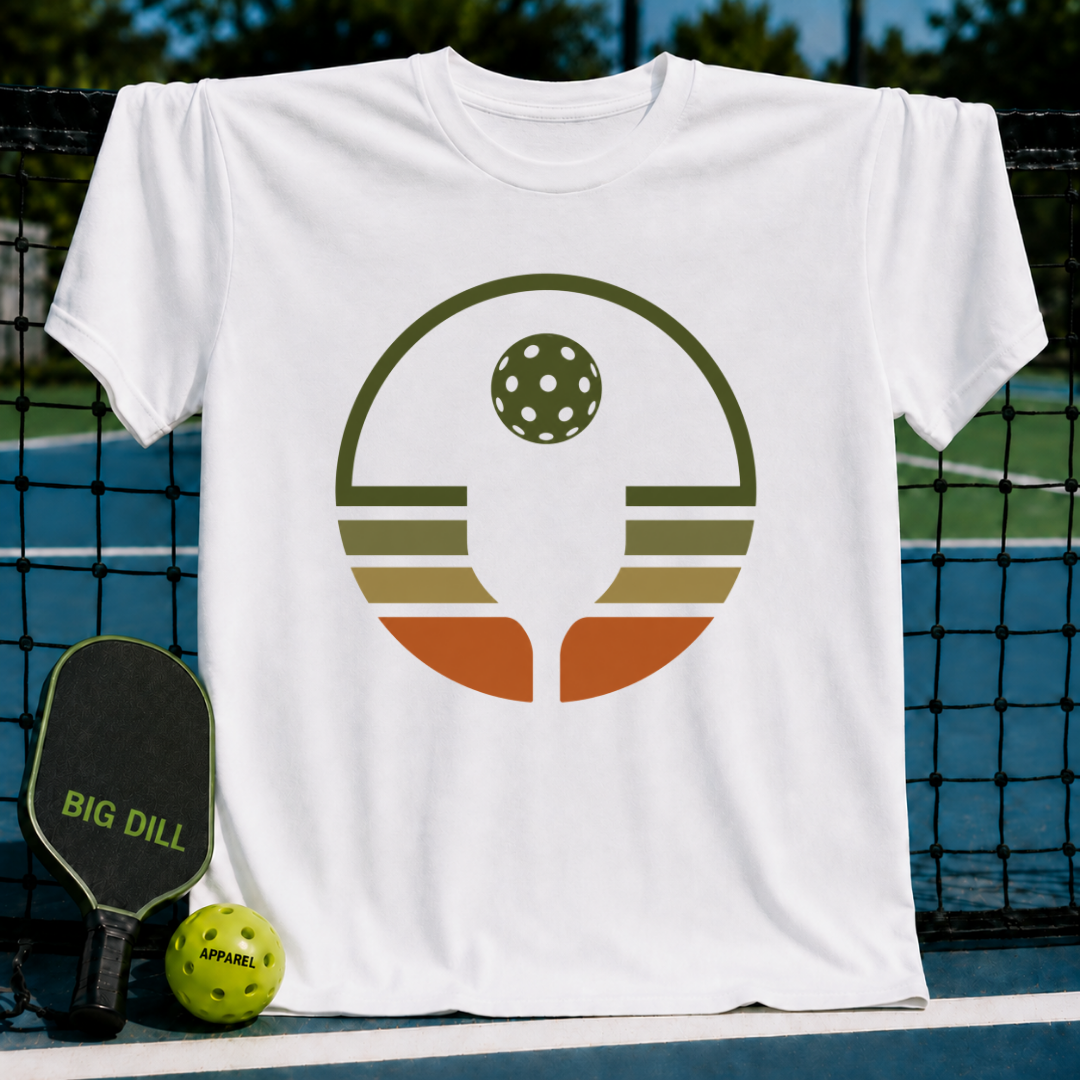 White unisex t-shirt featuring a retro circular pickleball graphic in olive, rust, and cream earth tones.
