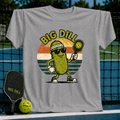 Grey unisex pickleball t-shirt featuring a retro sunset graphic of a cool pickle character with sunglasses and a paddle.