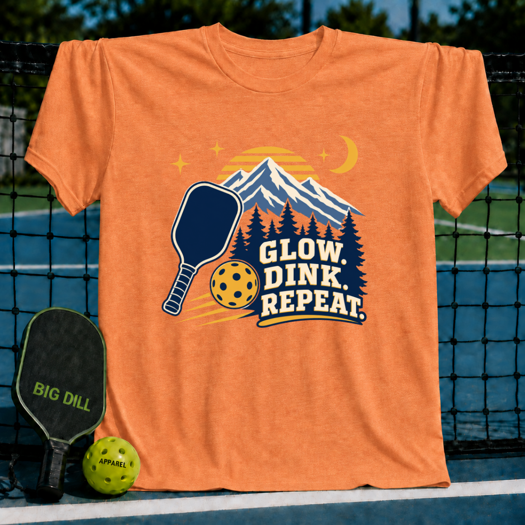 Orange crewneck t-shirt featuring a mountain, pickleball paddle, and ball graphic with the text Glow, Dink, Repeat.