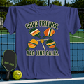 Purple cotton t-shirt featuring a pickleball graphic with four paddles and a ball, displayed on a pickleball court net.
