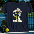 Navy blue t-shirt featuring a green alien holding a pickleball paddle next to a UFO with the text Close Encounters of the Dink Kind.