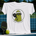 White unisex t-shirt featuring a circular graphic of a smiling pickle wearing sunglasses and a visor holding a pickleball paddle.