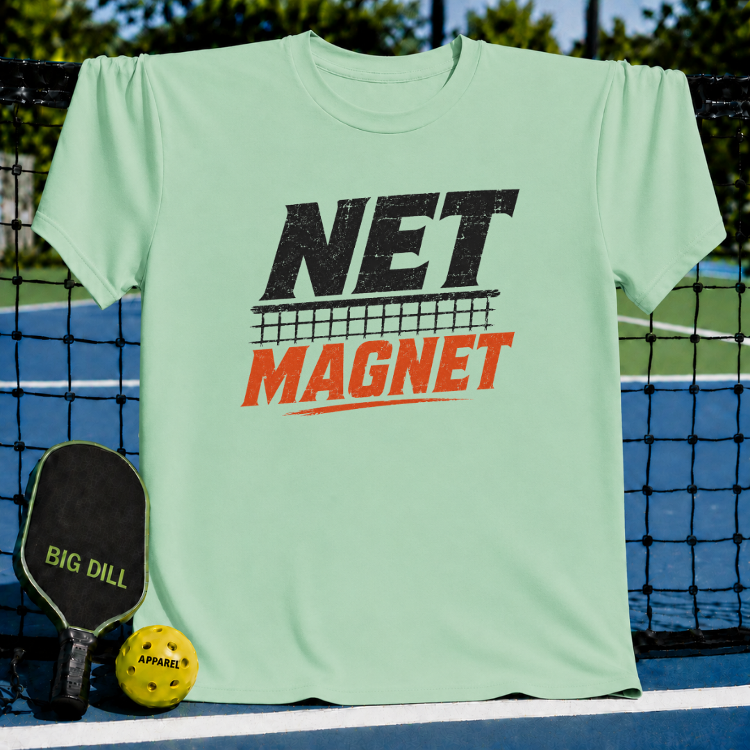 Vibrant teal unisex T-shirt featuring a distressed black and red Net Magnet graphic, displayed on a pickleball court net.