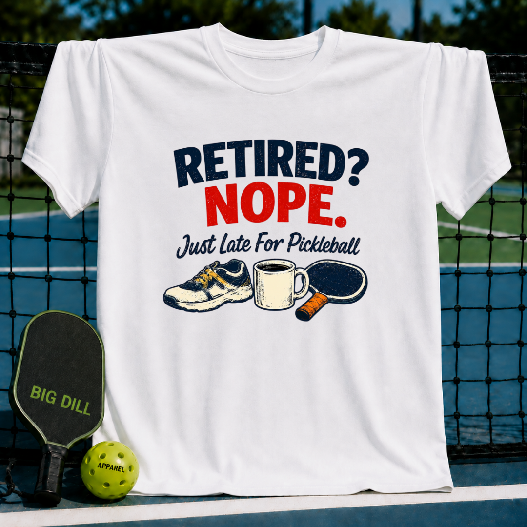 White crew neck t-shirt featuring a Retired? Nope. Just Late For Pickleball graphic with a sneaker, mug, and paddle.