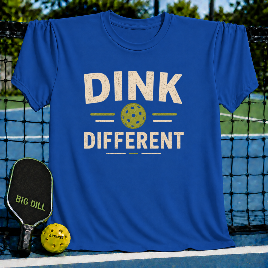 Royal blue crewneck t-shirt featuring a vintage-style Dink Different pickleball graphic on a court background.