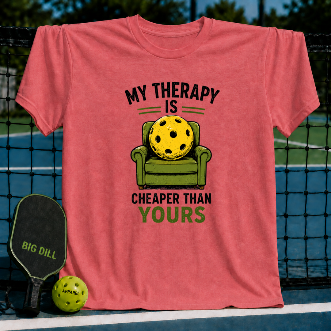 Coral unisex t-shirt featuring a yellow pickleball sitting in a green armchair with the text My Therapy Is Cheaper Than Yours.