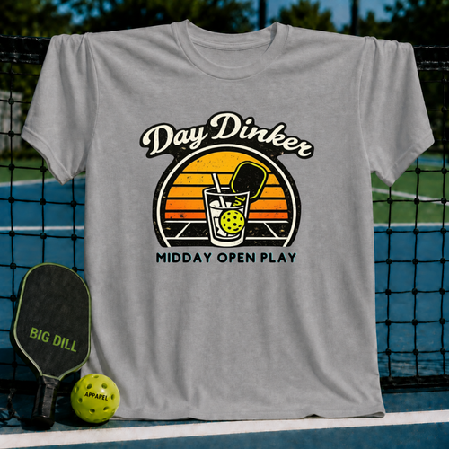 Grey unisex t-shirt featuring a retro sunset graphic of a pickleball paddle and ball in a glass with Day Dinker text.
