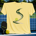 Light yellow crew neck t-shirt featuring a green pickleball-inspired graphic design, displayed on a pickleball court.
