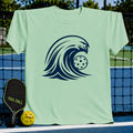 Mint green unisex t-shirt featuring a bold navy blue wave graphic with a pickleball inside on a pickleball court.