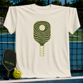 Cream-colored unisex t-shirt featuring a minimalist forest green pickleball paddle graphic with flowing wave lines.