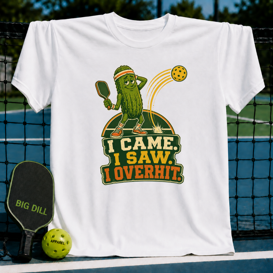 White cotton t-shirt featuring a cartoon pickle playing pickleball with the text I Came, I Saw, I Overhit.
