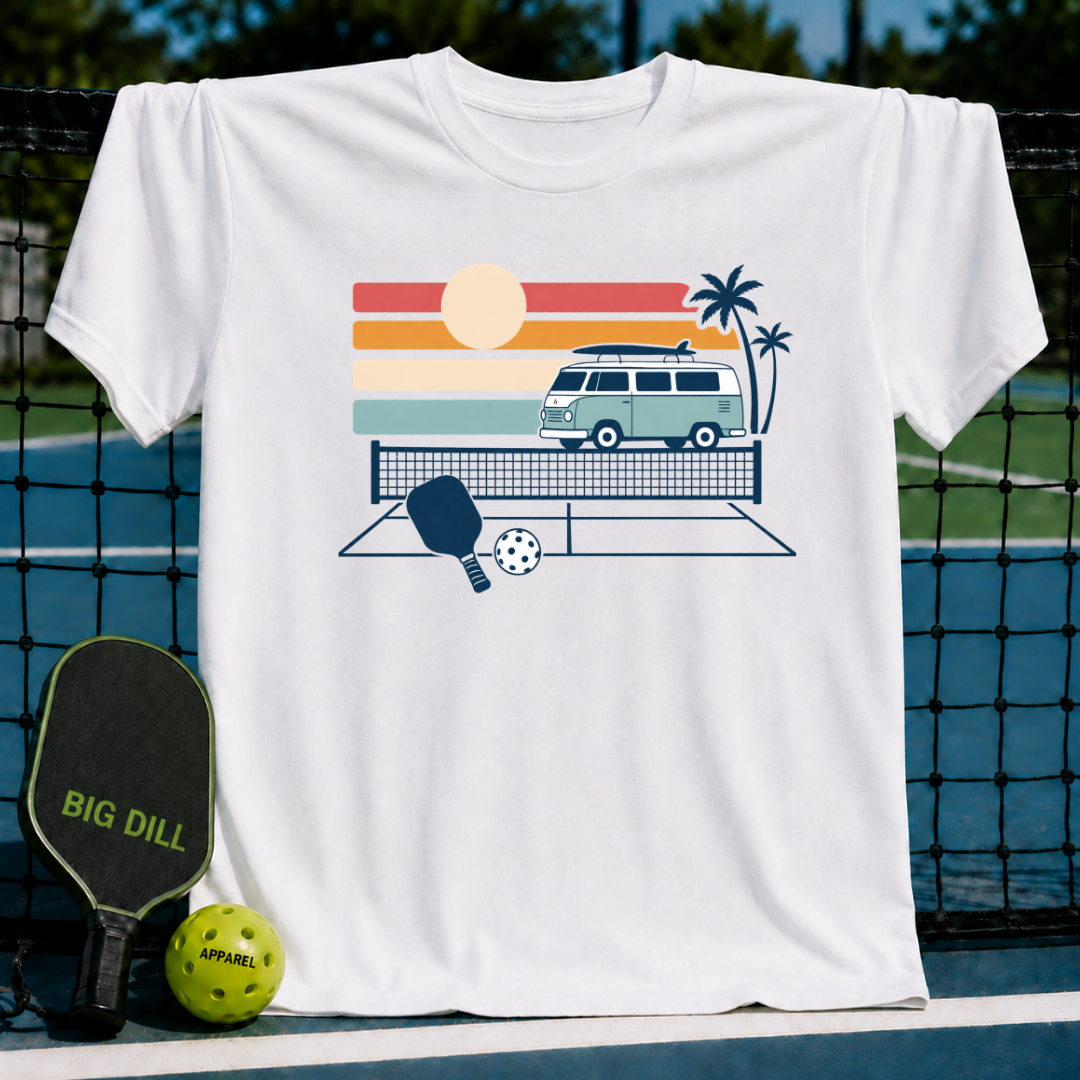 White cotton t-shirt featuring a retro van, palm trees, and pickleball court graphic on a pickleball court background.