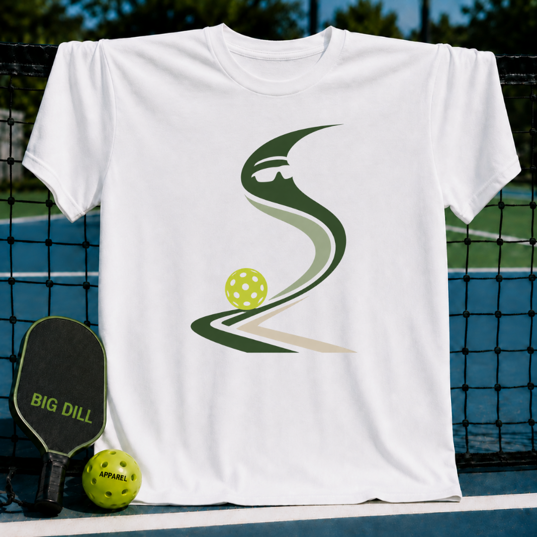 White crew neck t-shirt featuring a green abstract pickleball graphic, displayed on a pickleball court with a paddle.
