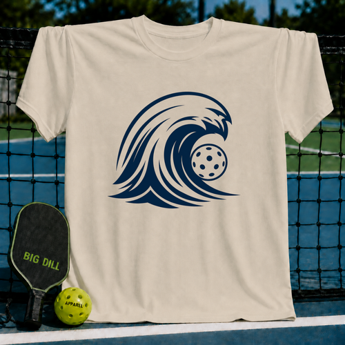 Light beige unisex t-shirt featuring a bold navy blue wave graphic with a pickleball, displayed on a pickleball court.