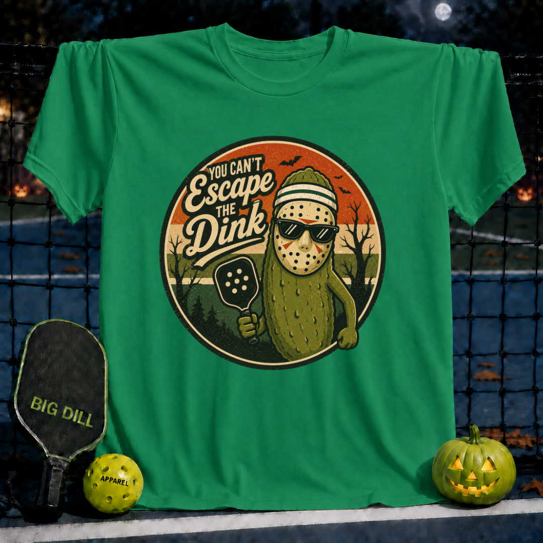 Kelly green unisex t-shirt featuring a pickleball-themed Halloween graphic of a pickle wearing a hockey mask and sunglasses.