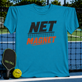 Vibrant teal unisex t-shirt featuring a distressed black and red Net Magnet graphic hanging on a pickleball court net.