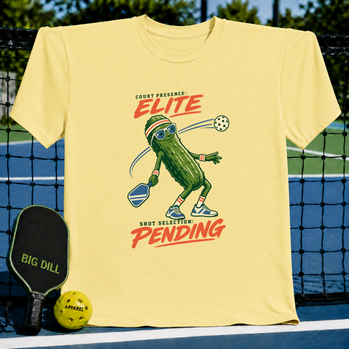 Light yellow crewneck T-shirt featuring a pickleball-playing pickle graphic with text on a pickleball court background.