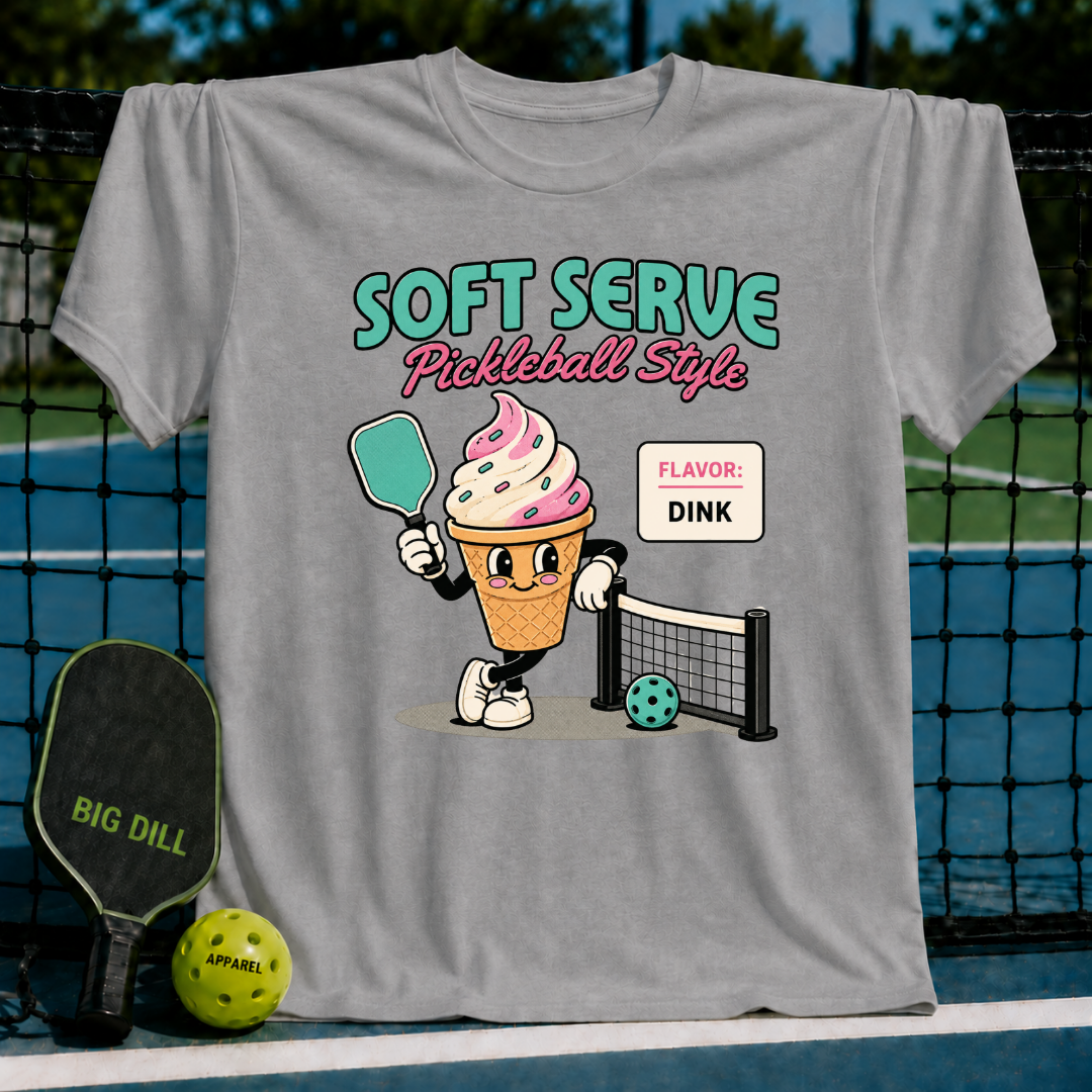 Grey unisex t-shirt featuring a retro ice cream cone character holding a pickleball paddle on a court background.
