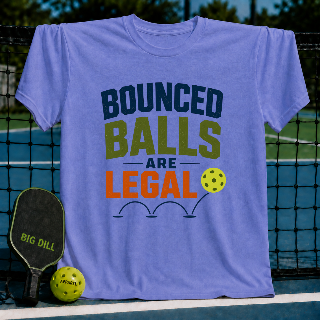 Periwinkle unisex pickleball t-shirt featuring bold Bounced Balls Are Legal typography and a yellow ball graphic.