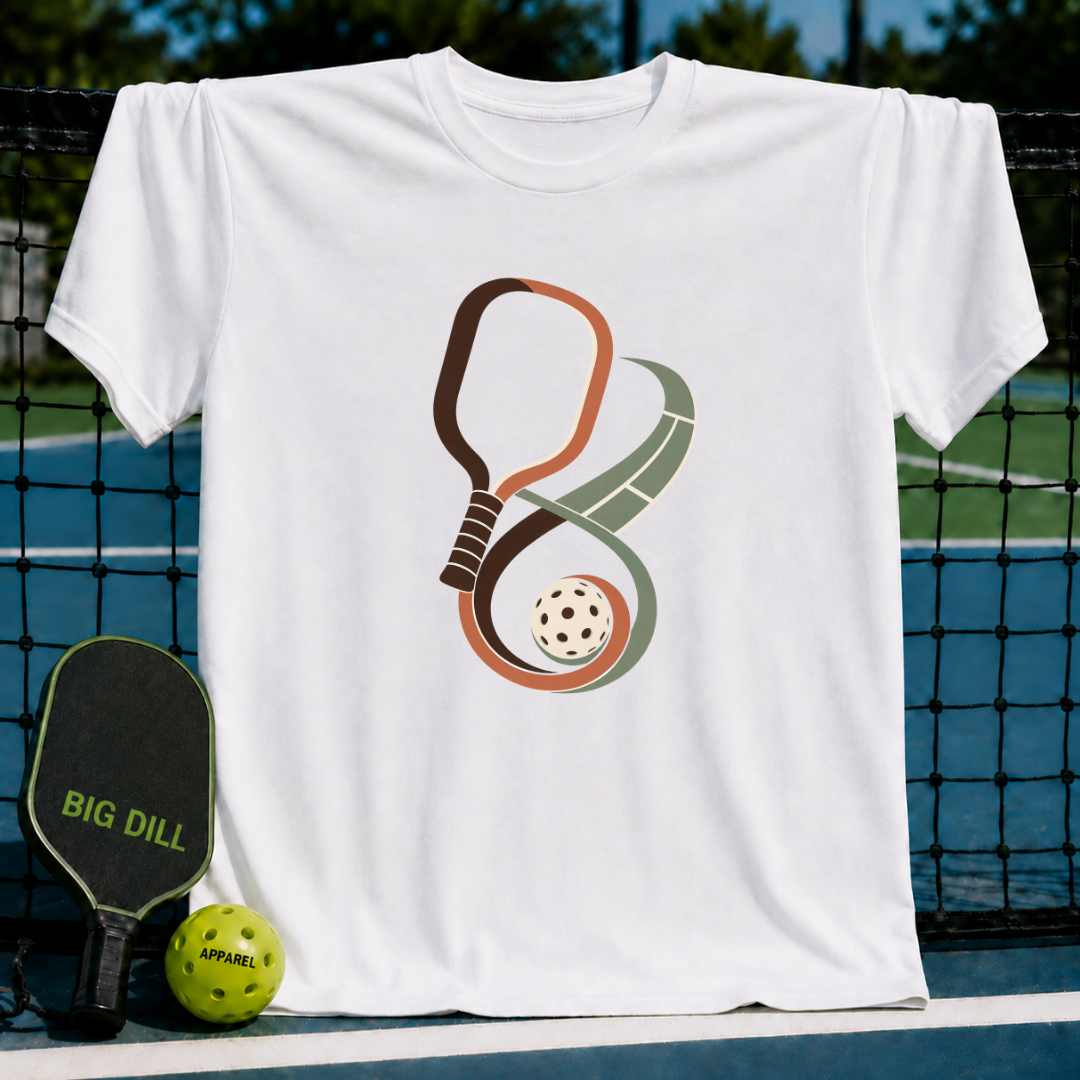 White crew neck t-shirt featuring an infinity-shaped pickleball paddle and court graphic with a ball on a court background.
