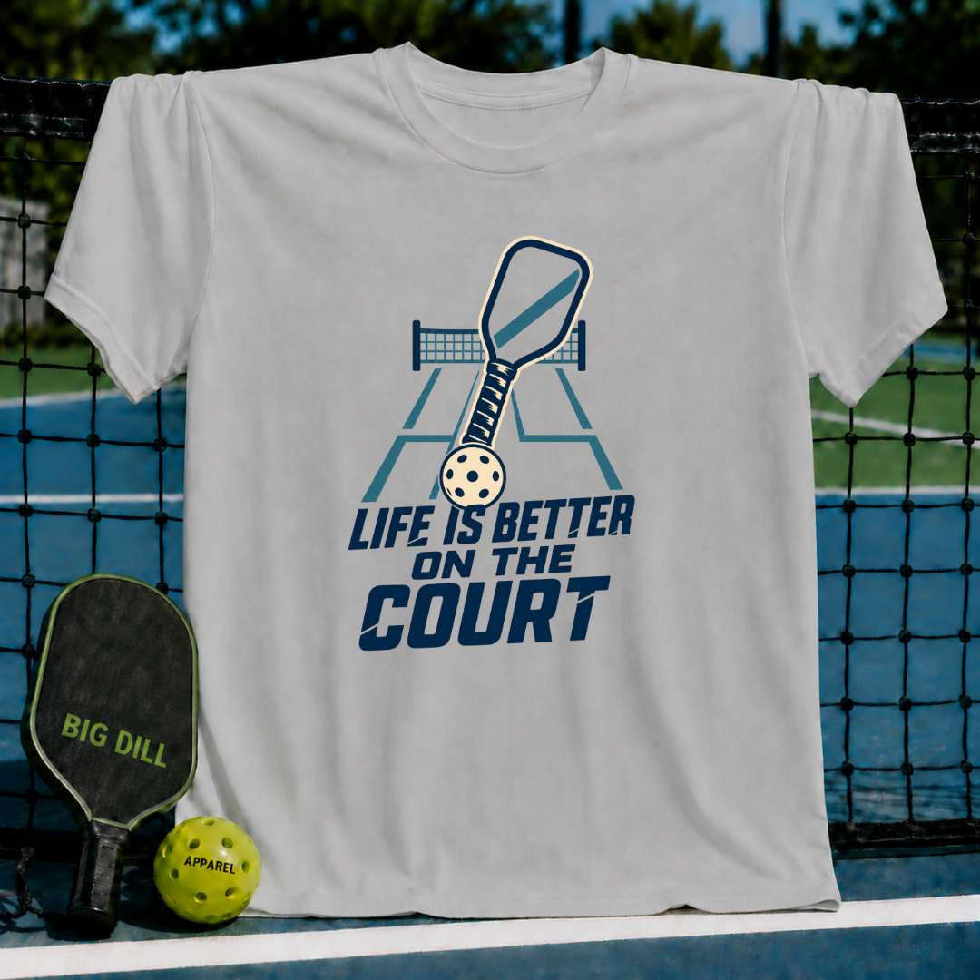 Light gray crew neck t-shirt featuring a blue pickleball paddle and court graphic with the text Life is Better on the Court.