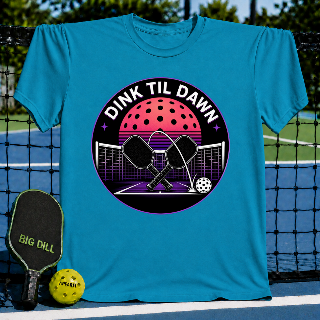 Blue unisex t-shirt featuring a retro synthwave pickleball graphic with crossed paddles and a neon moon design.