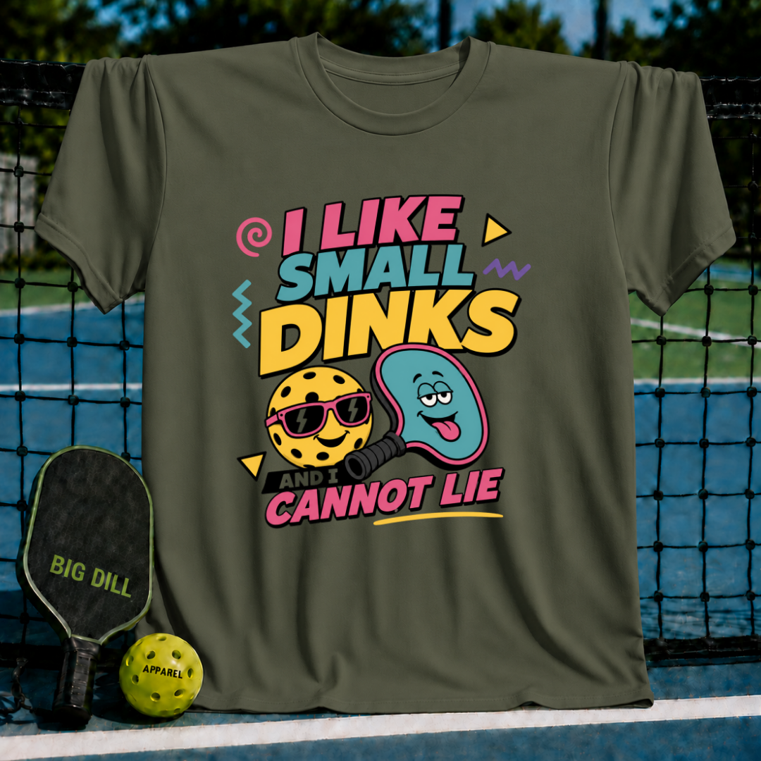Olive green crewneck t-shirt featuring a colorful pickleball graphic with a smiling ball and paddle design.