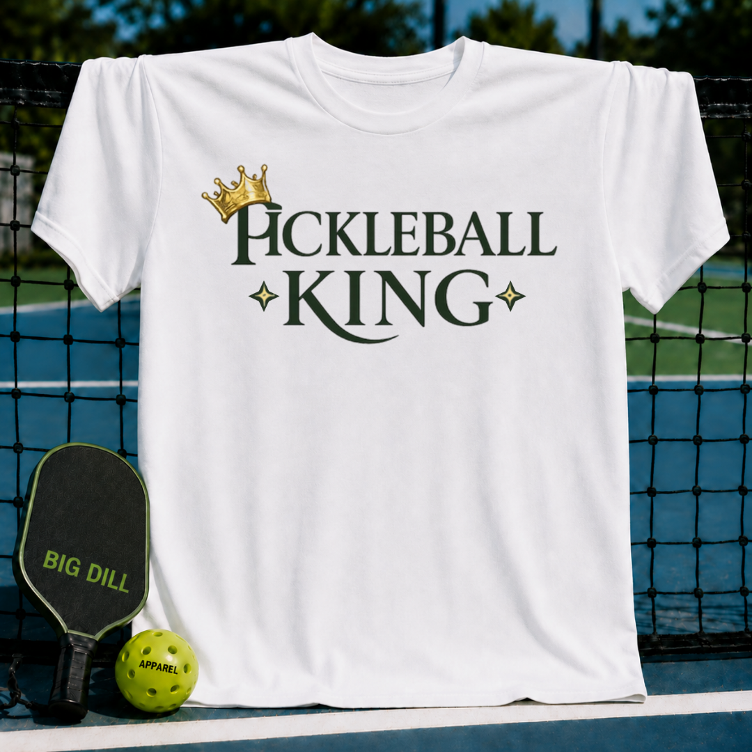 White unisex t-shirt featuring a gold crown and dark green Pickleball King text with star accents on a pickleball court.