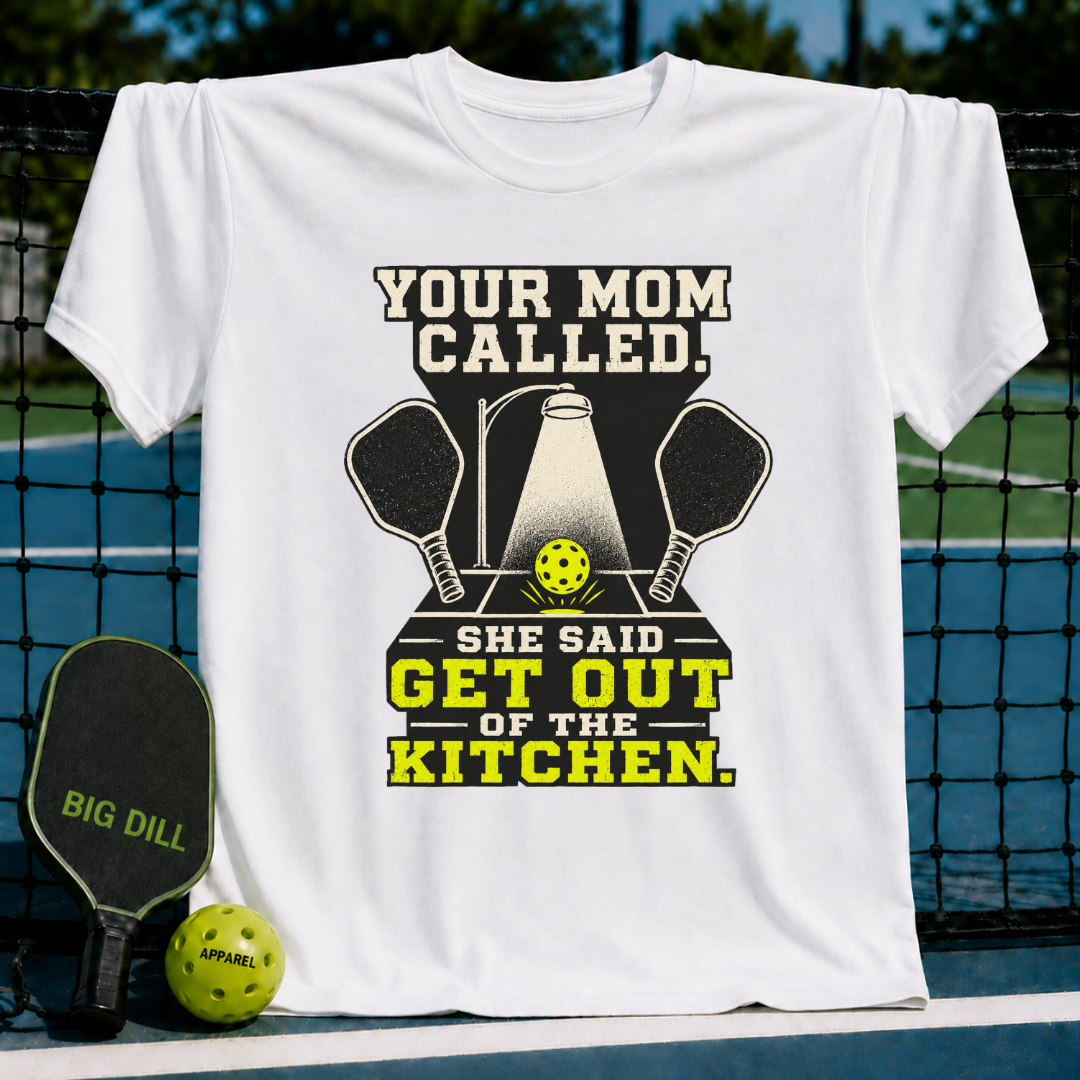 White unisex t-shirt featuring a pickleball graphic with crossed paddles, a spotlight on a ball, and the text Your Mom Called.