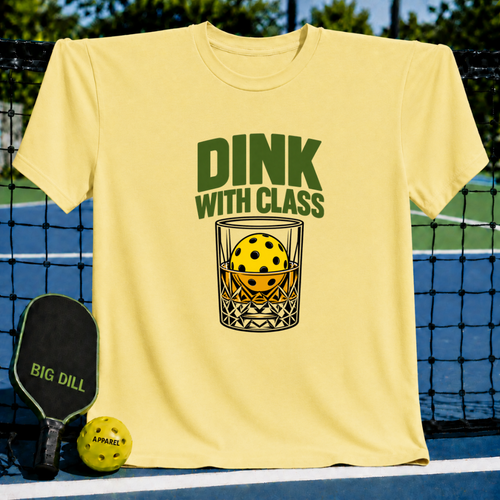 Light yellow crew neck t-shirt featuring a Dink With Class graphic of a pickleball inside a whiskey glass on a court.