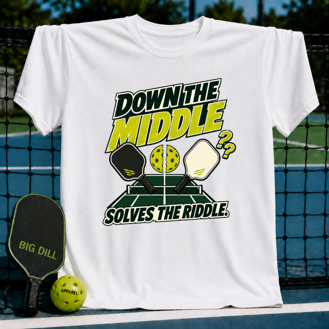 White crewneck t-shirt featuring a Down the Middle pickleball graphic with paddles and a split ball on a court background.