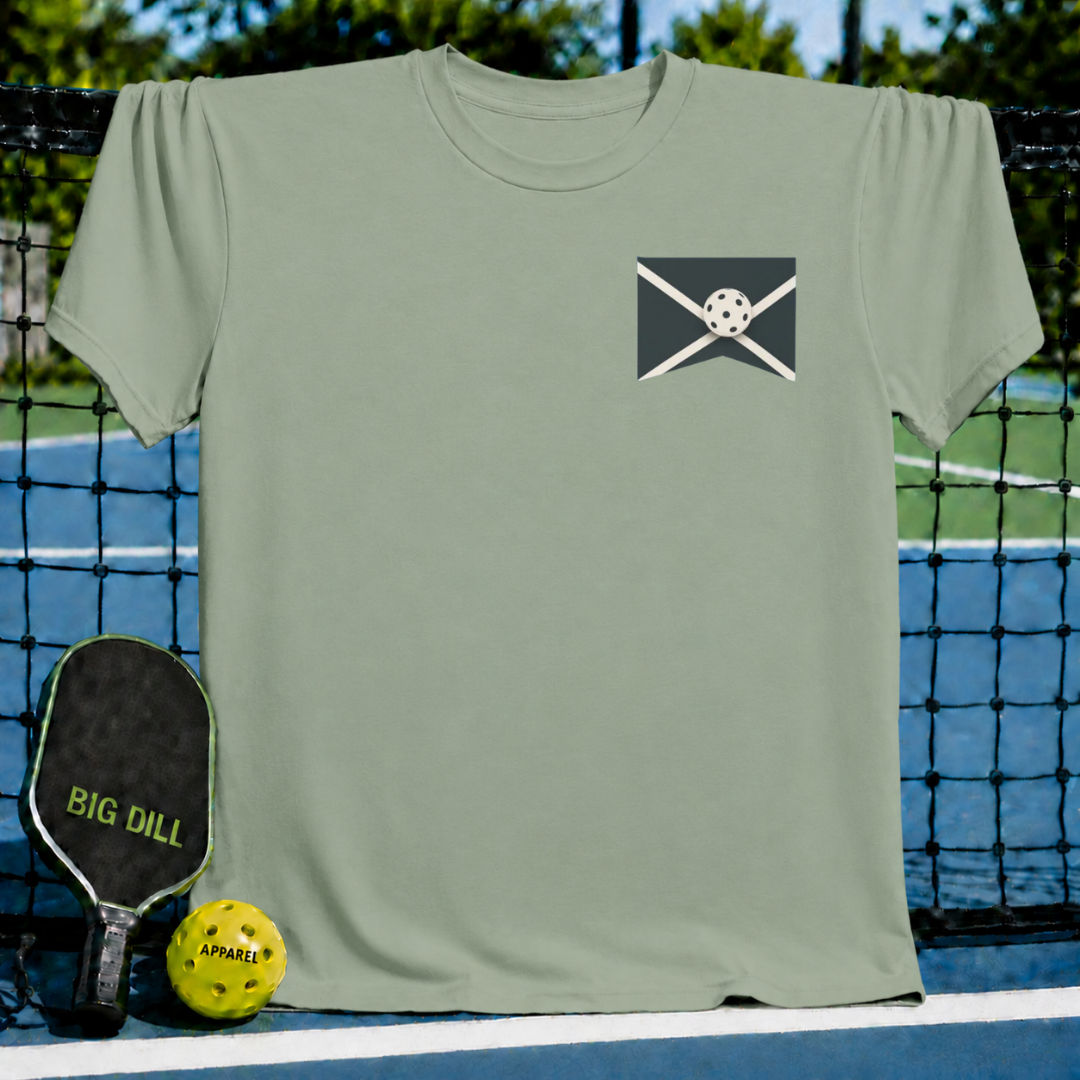 Sage green unisex T-shirt featuring a minimalist pickleball graphic on a pickleball court background.