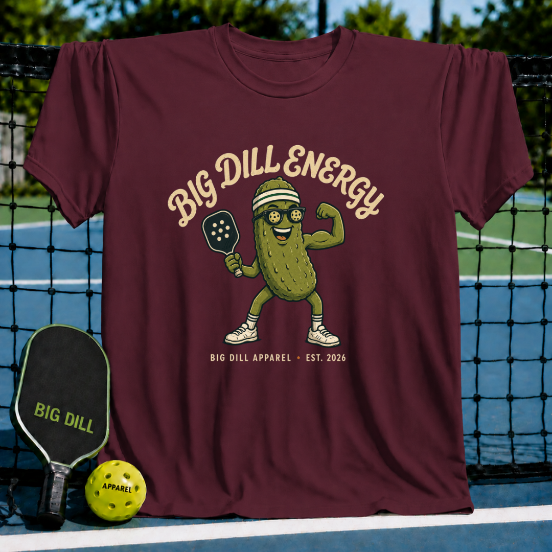 Maroon Big Dill Energy t-shirt featuring a pickle mascot with sunglasses, a visor, and a pickleball paddle.
