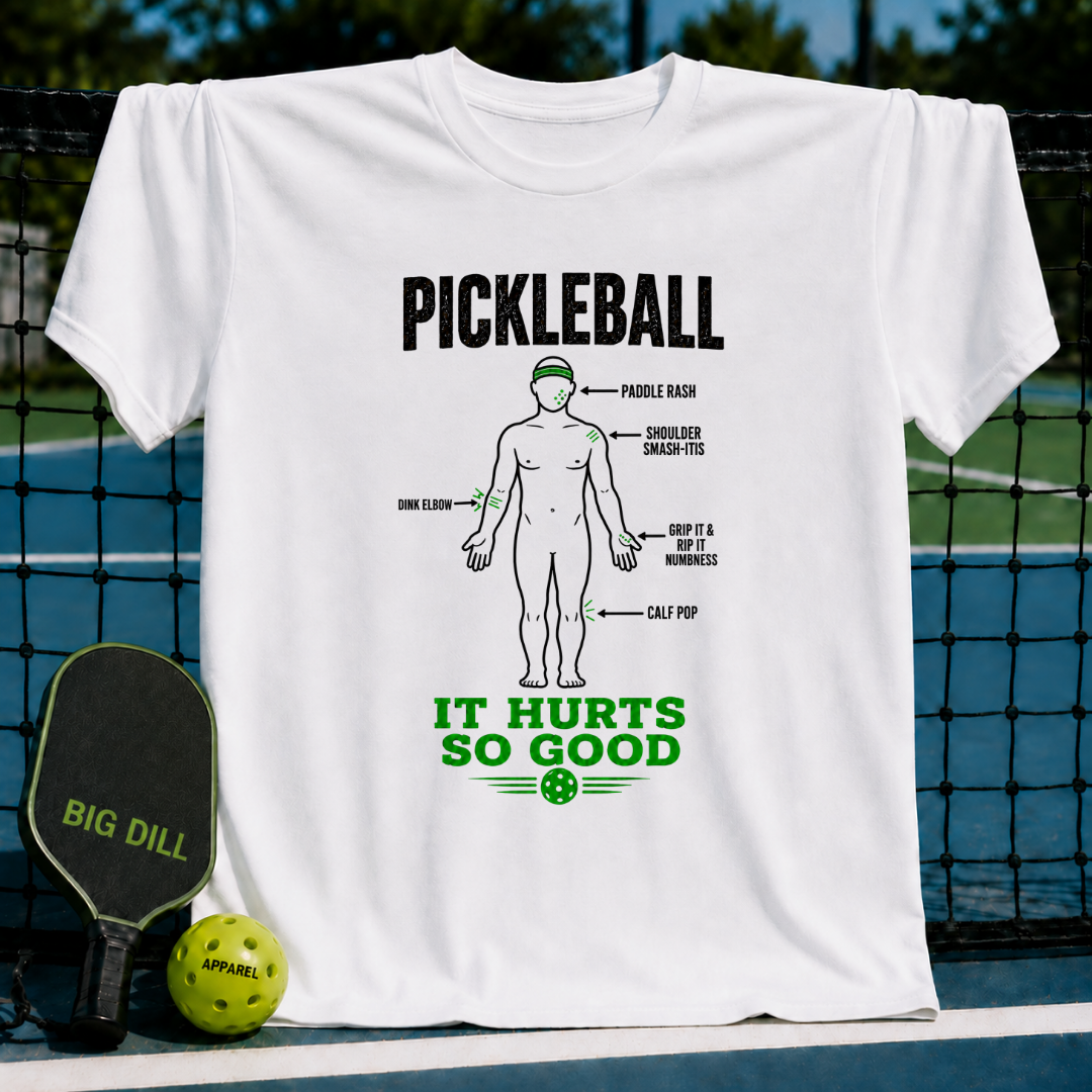 White cotton t-shirt featuring a humorous Pickleball anatomy diagram with green and black text against a pickleball court.