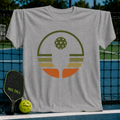 Heather gray unisex t-shirt featuring a retro pickleball circle graphic in olive, rust, and cream earth tones.