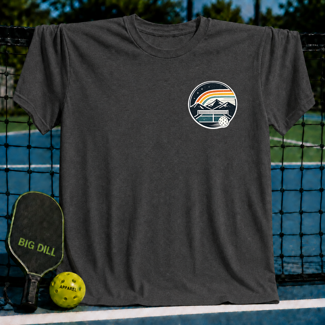 Charcoal grey unisex t-shirt featuring a circular pickleball court crest graphic with mountains and a sunset.