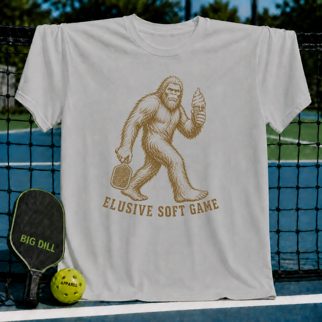 Light grey unisex t-shirt featuring a vintage Sasquatch graphic holding a pickleball paddle and a melting ice cream cone.