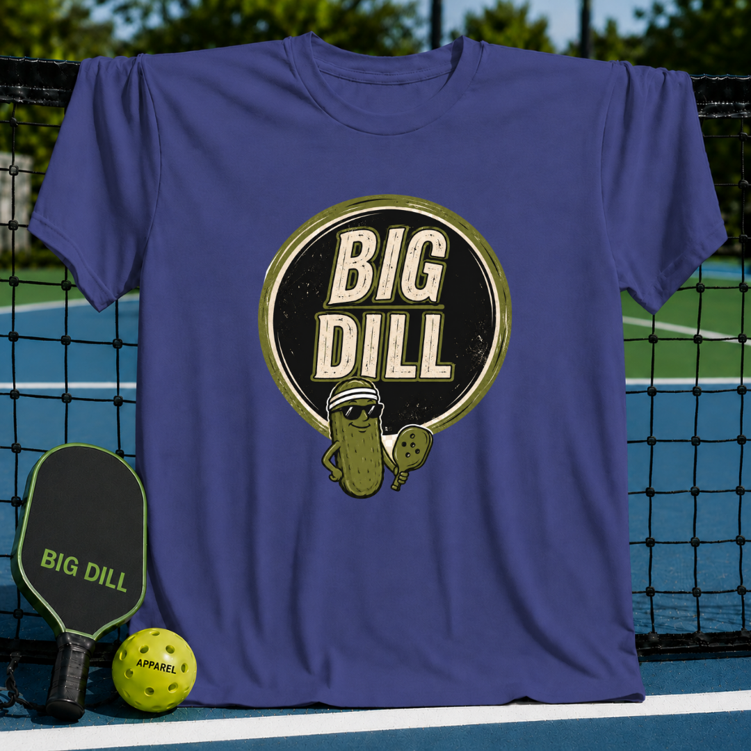 Blue crew neck t-shirt featuring a Big Dill pickle graphic with sunglasses and a pickleball paddle on a court background.