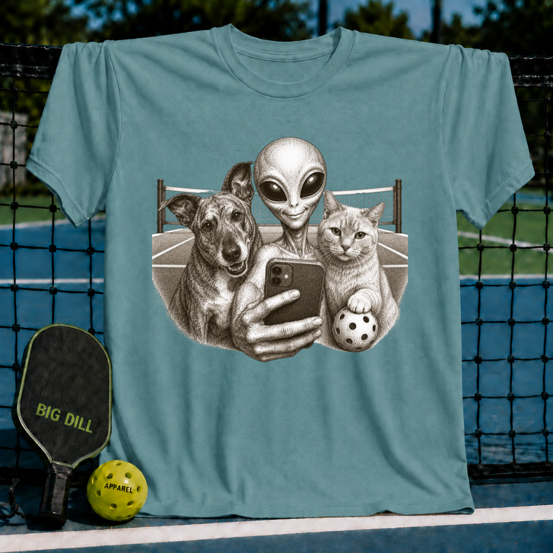 Heather green unisex t-shirt featuring a vintage-style illustration of an alien, dog, and cat taking a pickleball selfie.