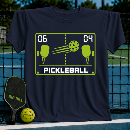 Navy blue unisex t-shirt featuring a retro green pixel-art pickleball graphic with paddles, a ball, and a 06-04 score.
