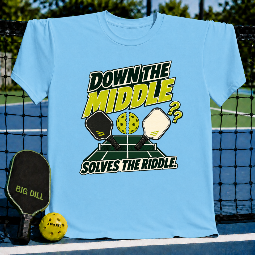 Light blue crew neck t-shirt featuring a pickleball court graphic with paddles and a cracked ball, displayed on a court net.