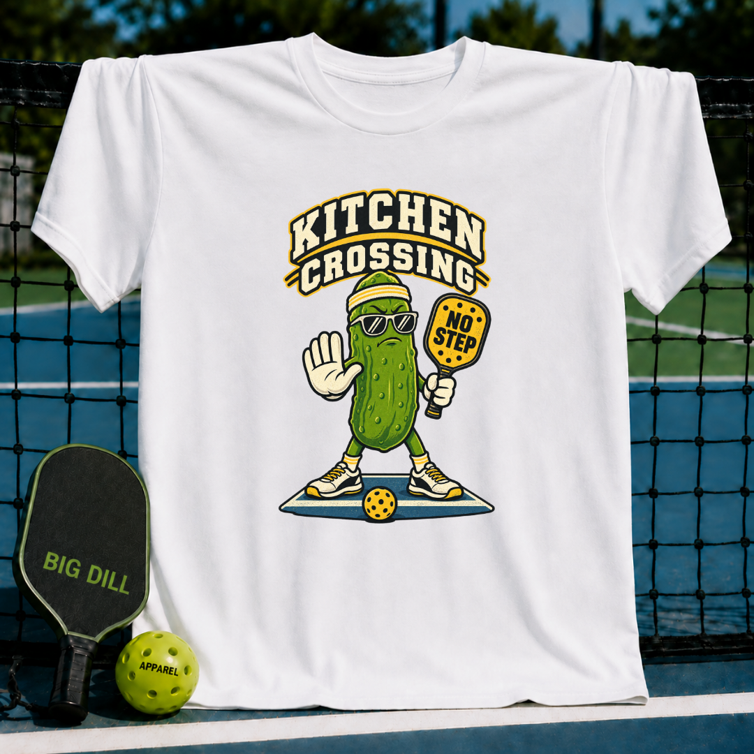 White crewneck t-shirt featuring a cartoon pickle wearing sunglasses and holding a No Step pickleball paddle.