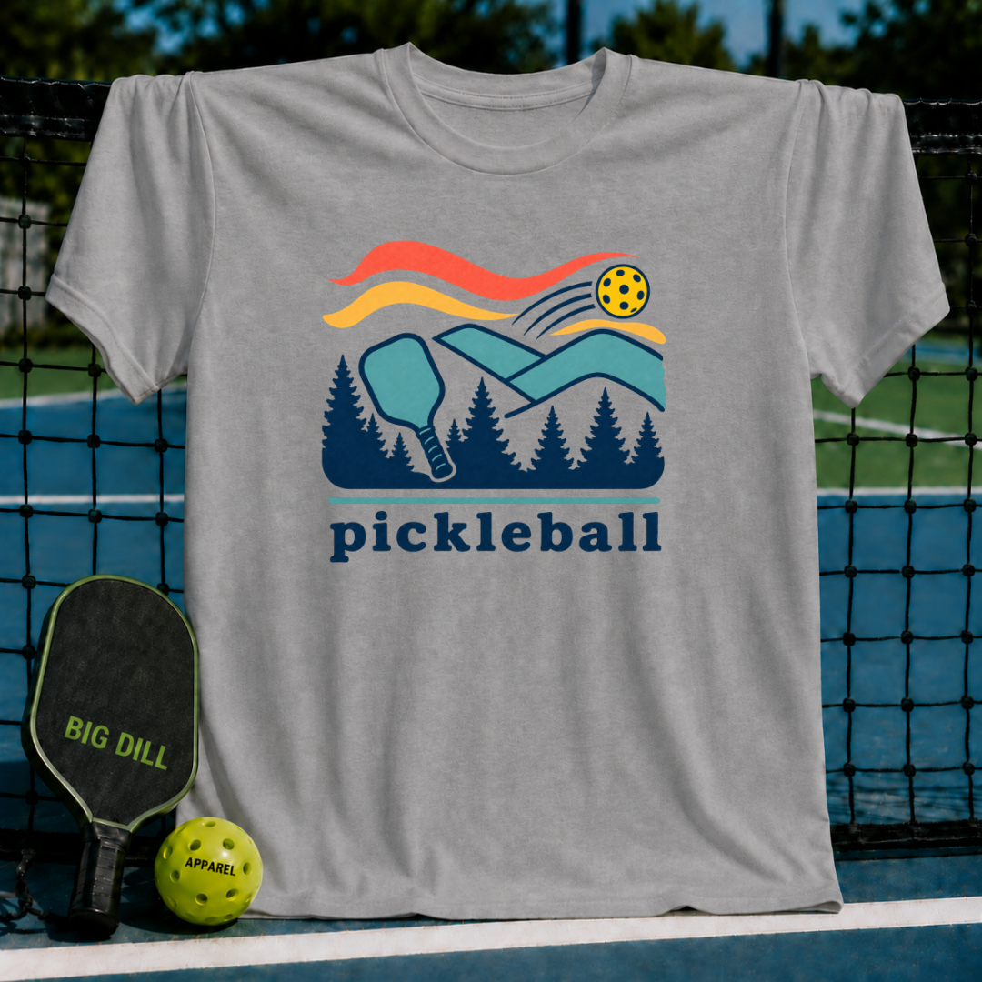 Grey cotton t-shirt featuring a colorful pickleball court, paddle, and forest graphic with the word pickleball below.