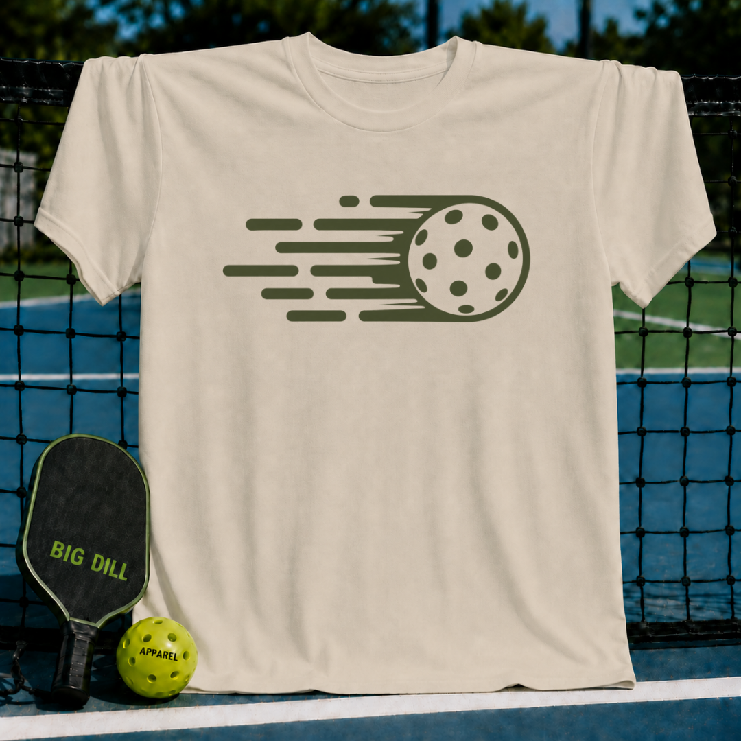 Beige unisex t-shirt featuring a dark green graphic of a pickleball in motion, displayed on a pickleball court net.