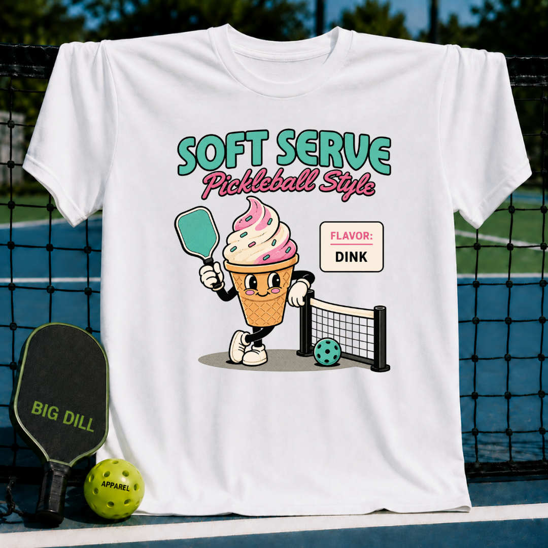 Cream-colored unisex t-shirt featuring a retro ice cream cone character holding a pickleball paddle on a court.