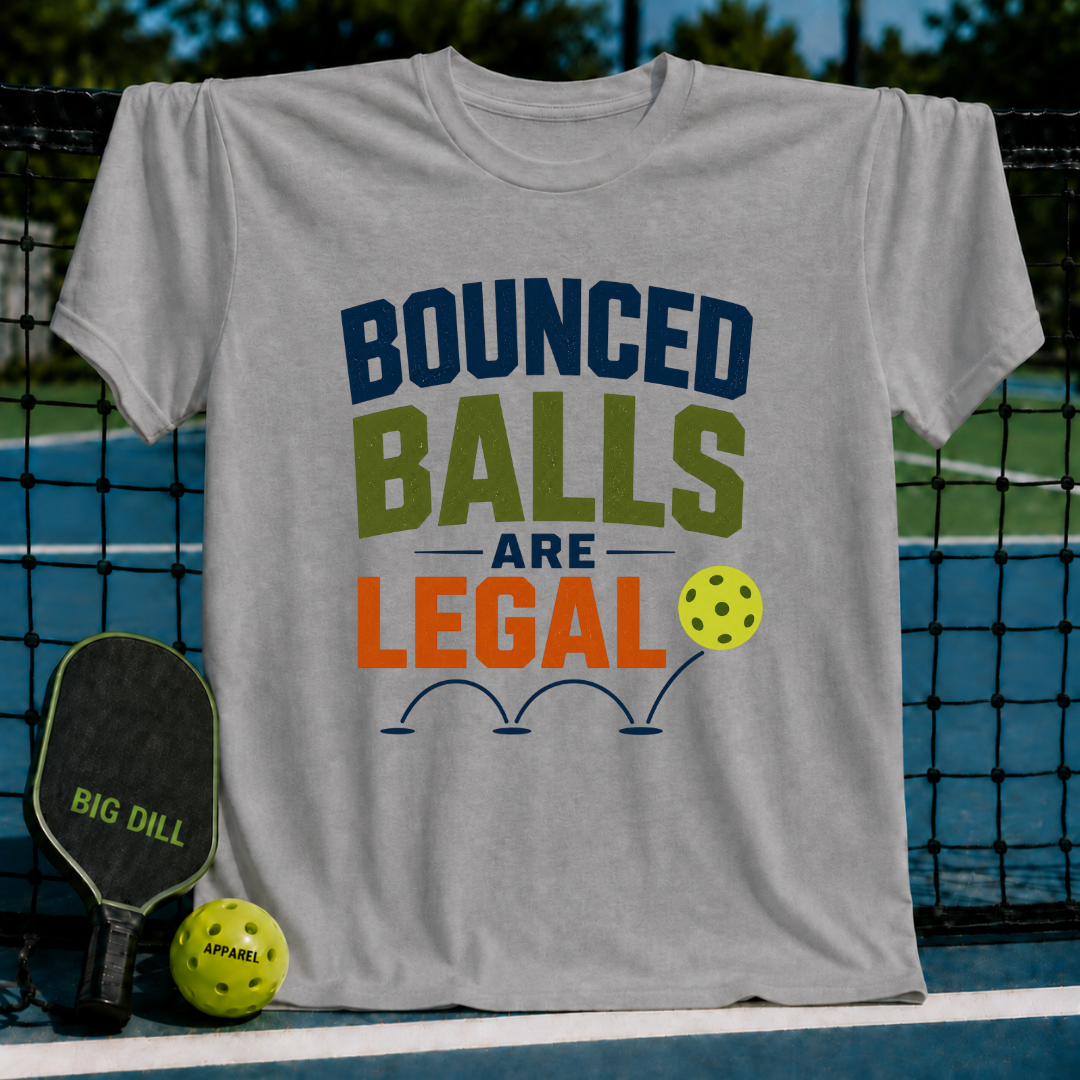 Light gray unisex pickleball t-shirt featuring Bounced Balls Are Legal text in blue, green, and orange on a court background.
