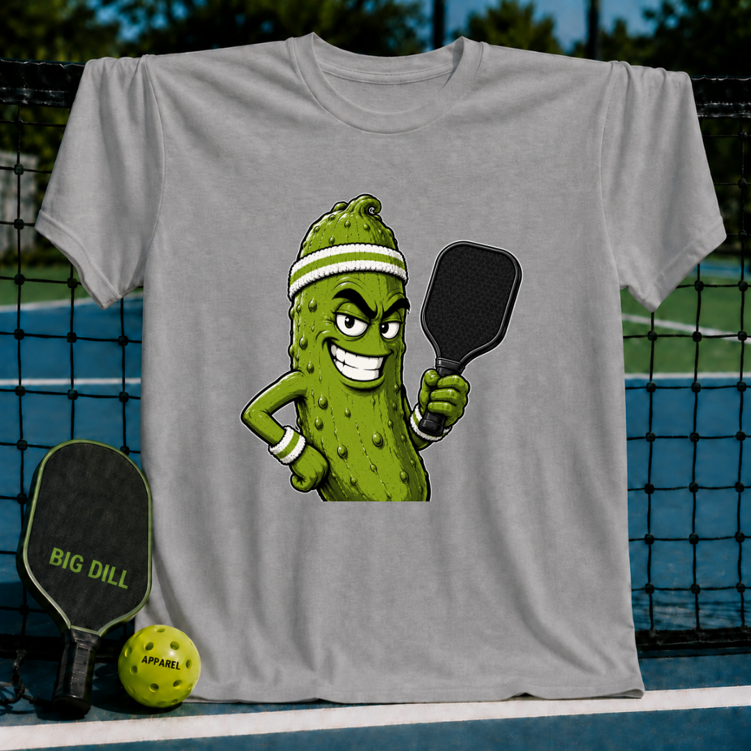 Grey unisex t-shirt featuring a smirking pickle character wearing a sweatband and holding a pickleball paddle.