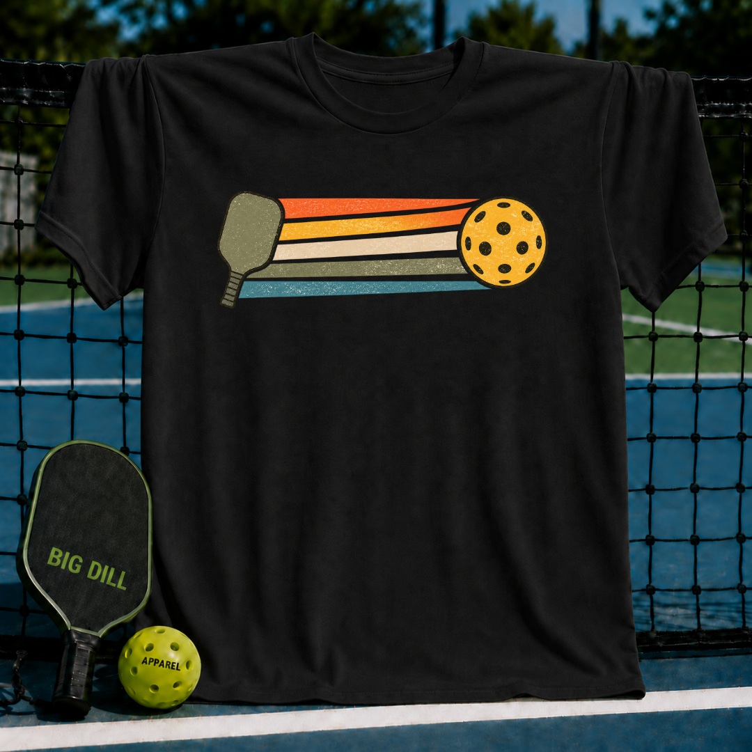 Black unisex t-shirt featuring a retro graphic of a pickleball paddle and ball with colorful motion stripes.